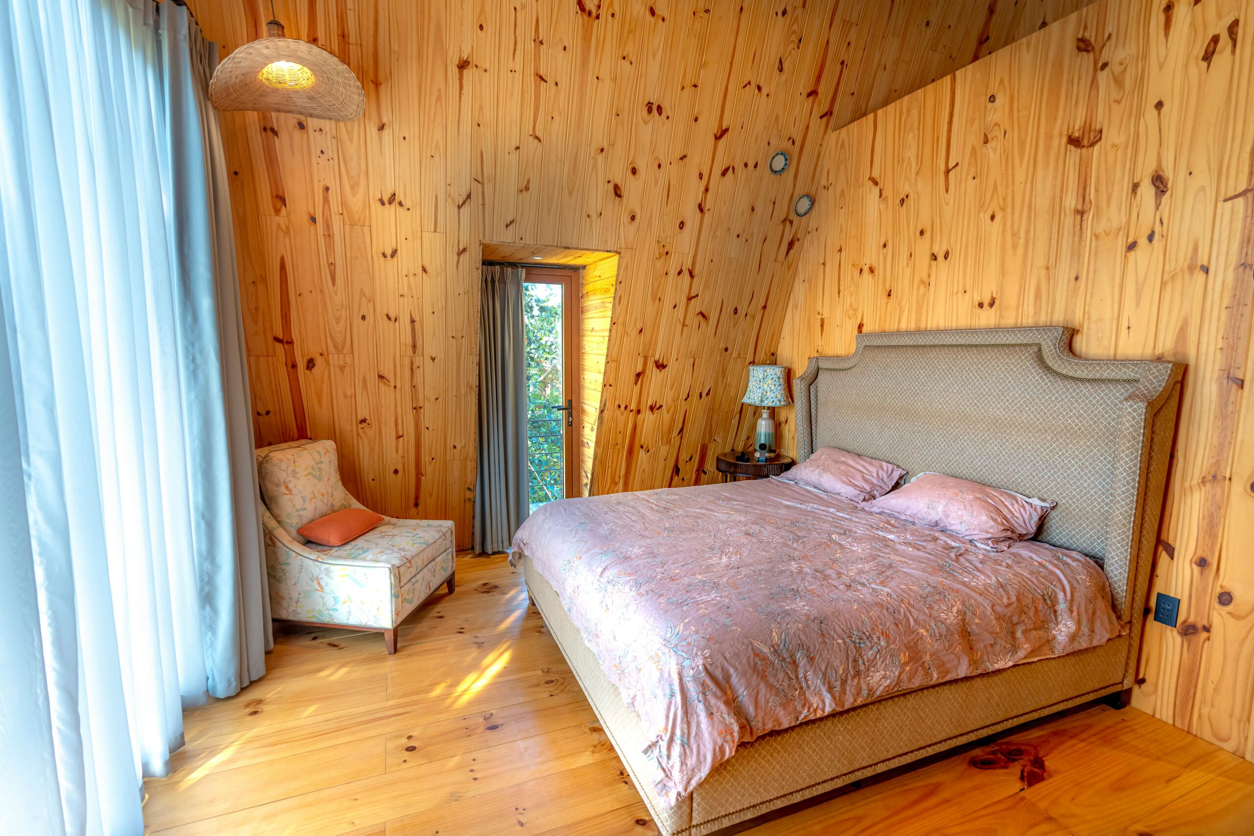 East Nashville cottage Warm and inviting bedroom showcasing wooden walls and soft lighting.