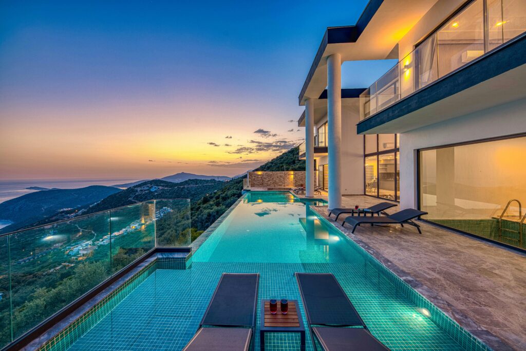 Altis Sky Villa Stunning luxury villa overlooking the ocean with an infinity pool at sunset.